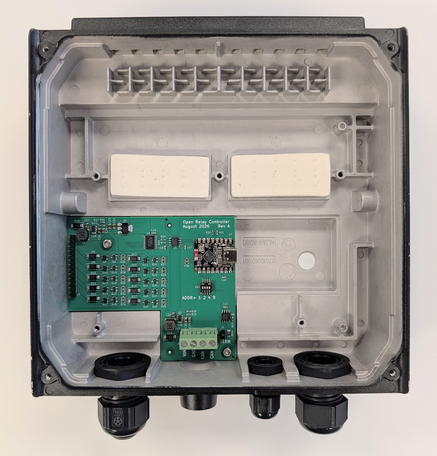 ORC Rev A PCB alone in the PMUN1046A enclosure, showing the CAN bus screw terminal, DIP address switches, and USB-C programming port