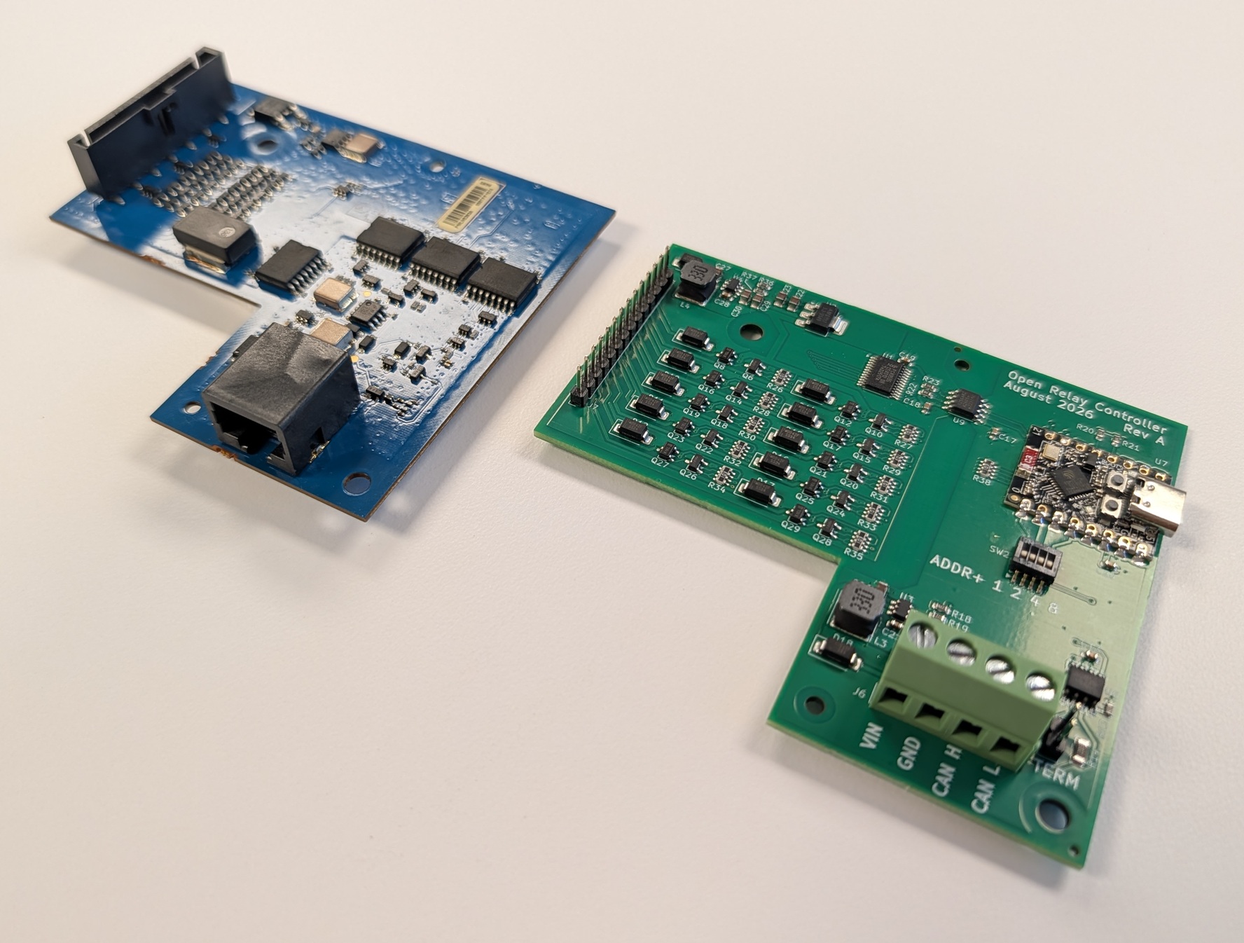 ORC Rev A (green, right) next to the OEM PMUN1046A control PCB (blue, left), angled view